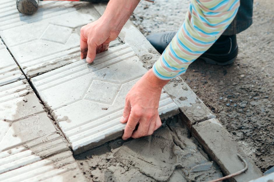 Worker placing tiles down
