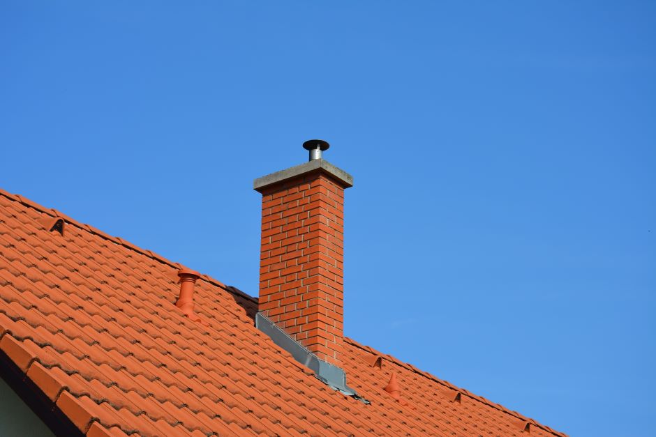 Roof of a house showing the chimney flashing made of bricks