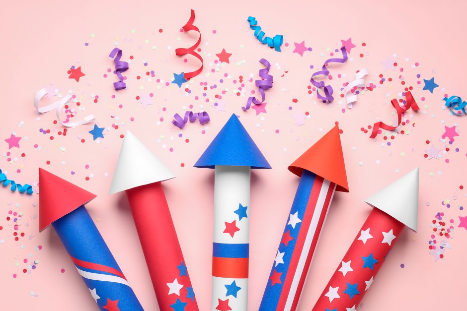 American firework rockets with confetti and serpentine in a pink background
