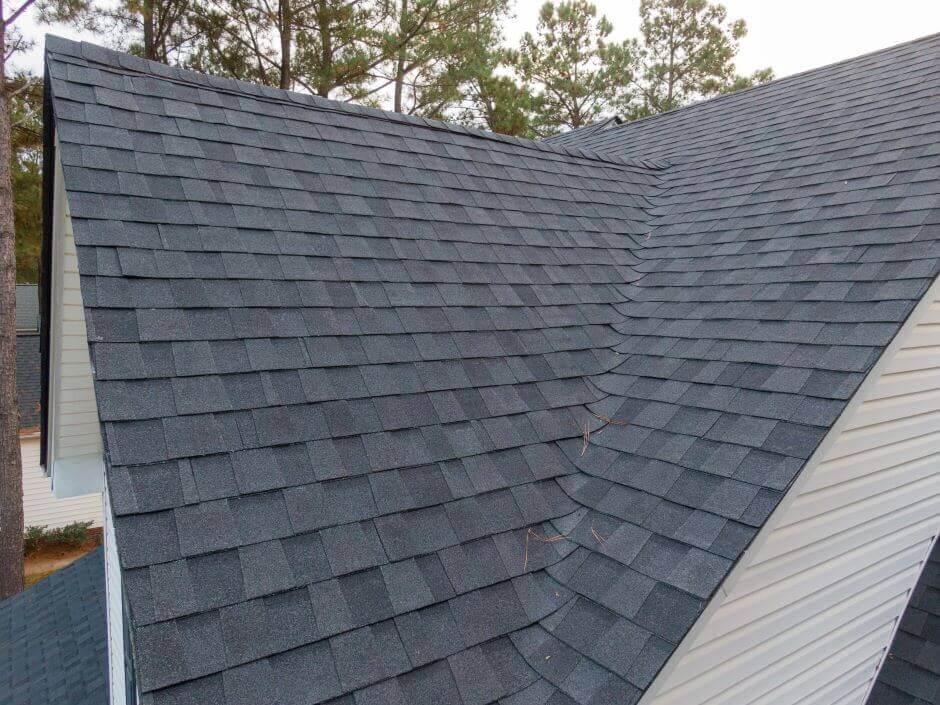 Image of a roof with architectural shingles, which are laminate or dimensional roof tiles.