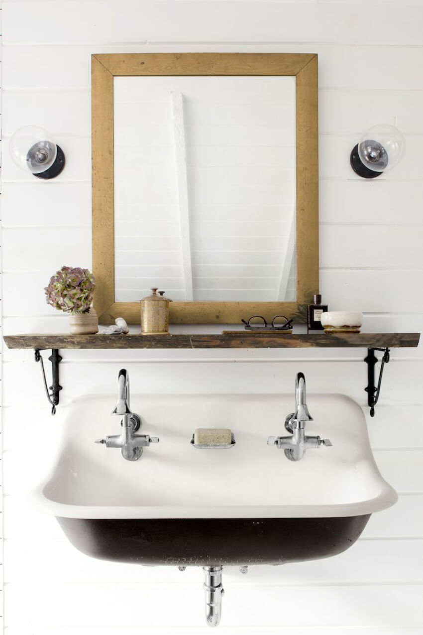 A floating shelf adds space to your small powder room. Source: House Beautiful