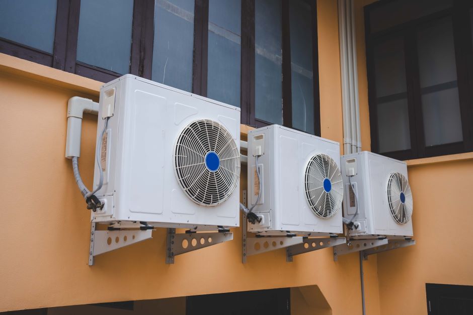 Three air conditioning units, fixed on a wall on your external side just below the window.