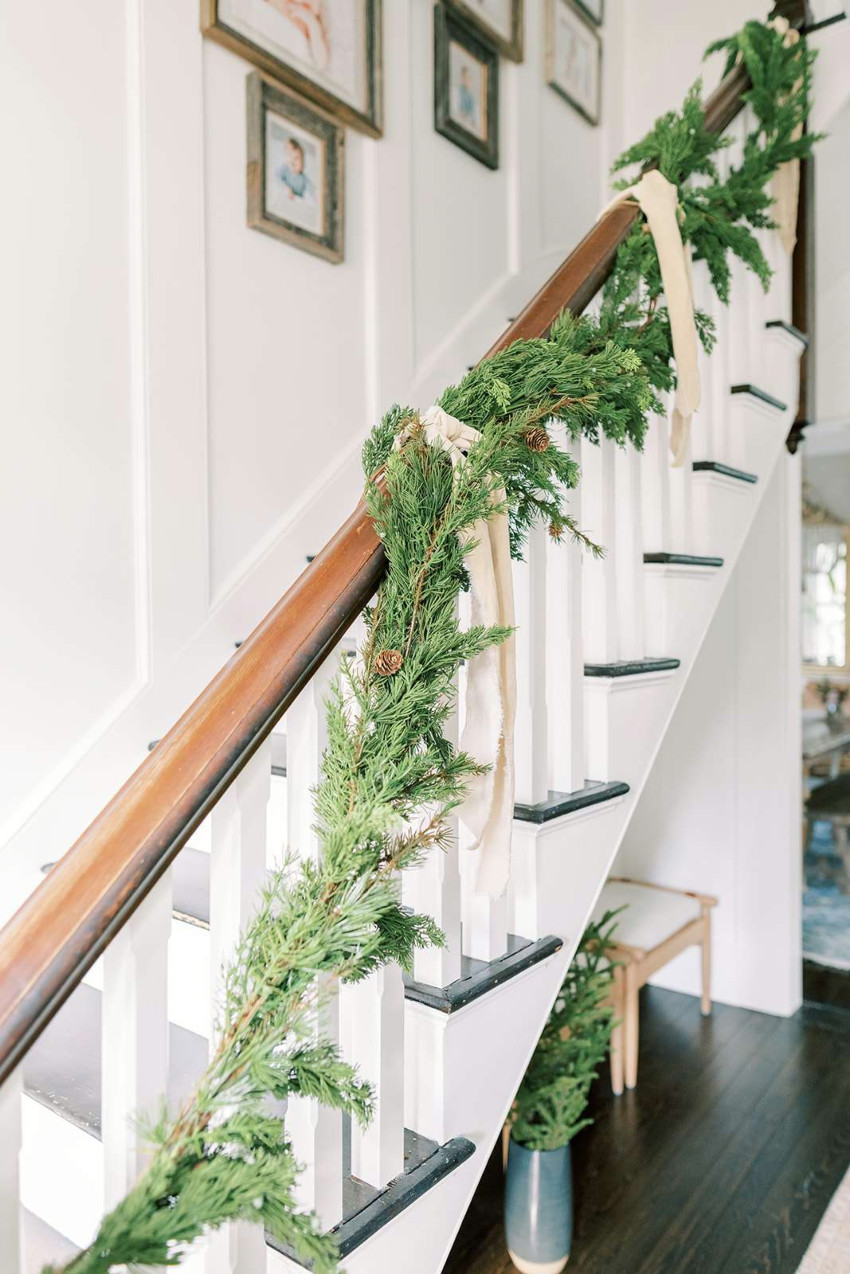 Garlands are perfect to decorate the stairs. Source: The Spruce