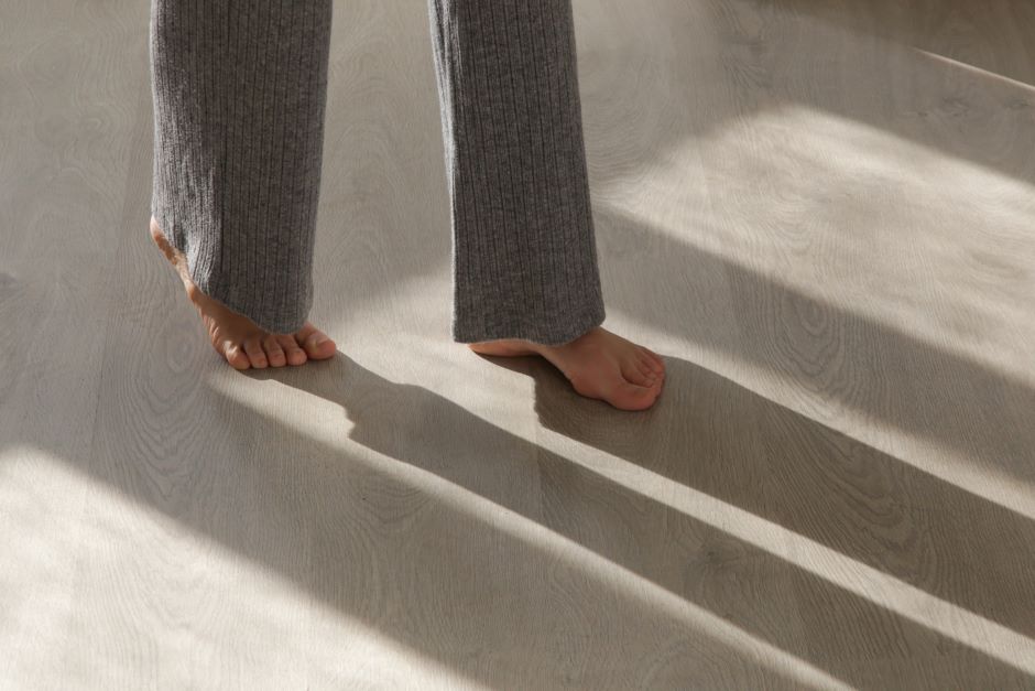  Woman walking barefoot on the floor of her home