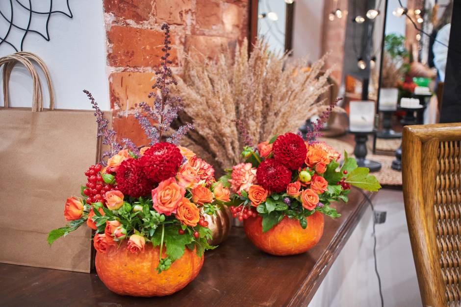 A bouquet of flowers inside of a pumpkin