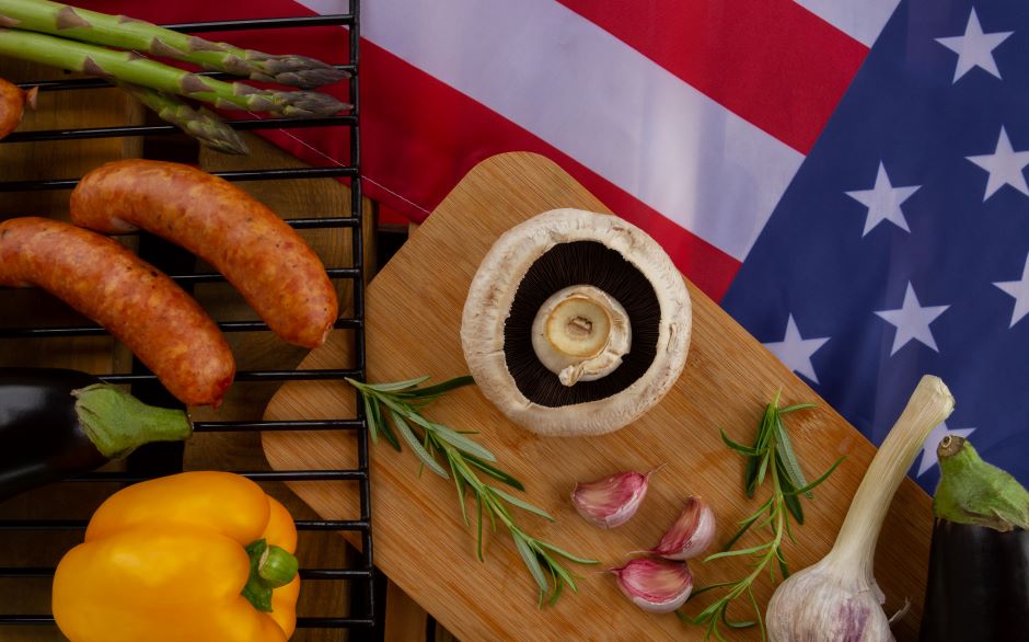 Vegetable and sausage arranged on a table with the american flag