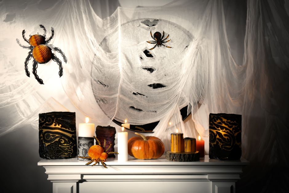 Mirror decorated with spiderwebs and Halloween-themed spiders