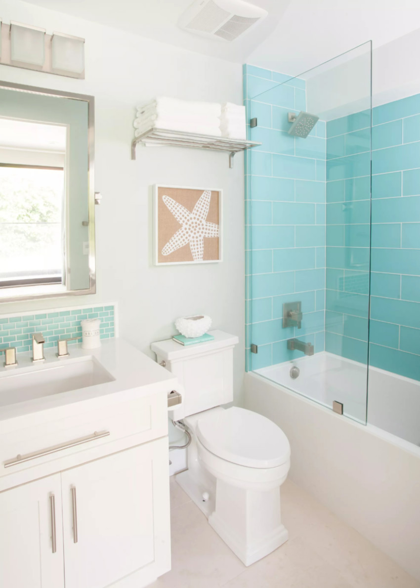 The tan floor tiles and blue walls create that coastal feeling. Source: The Spruce